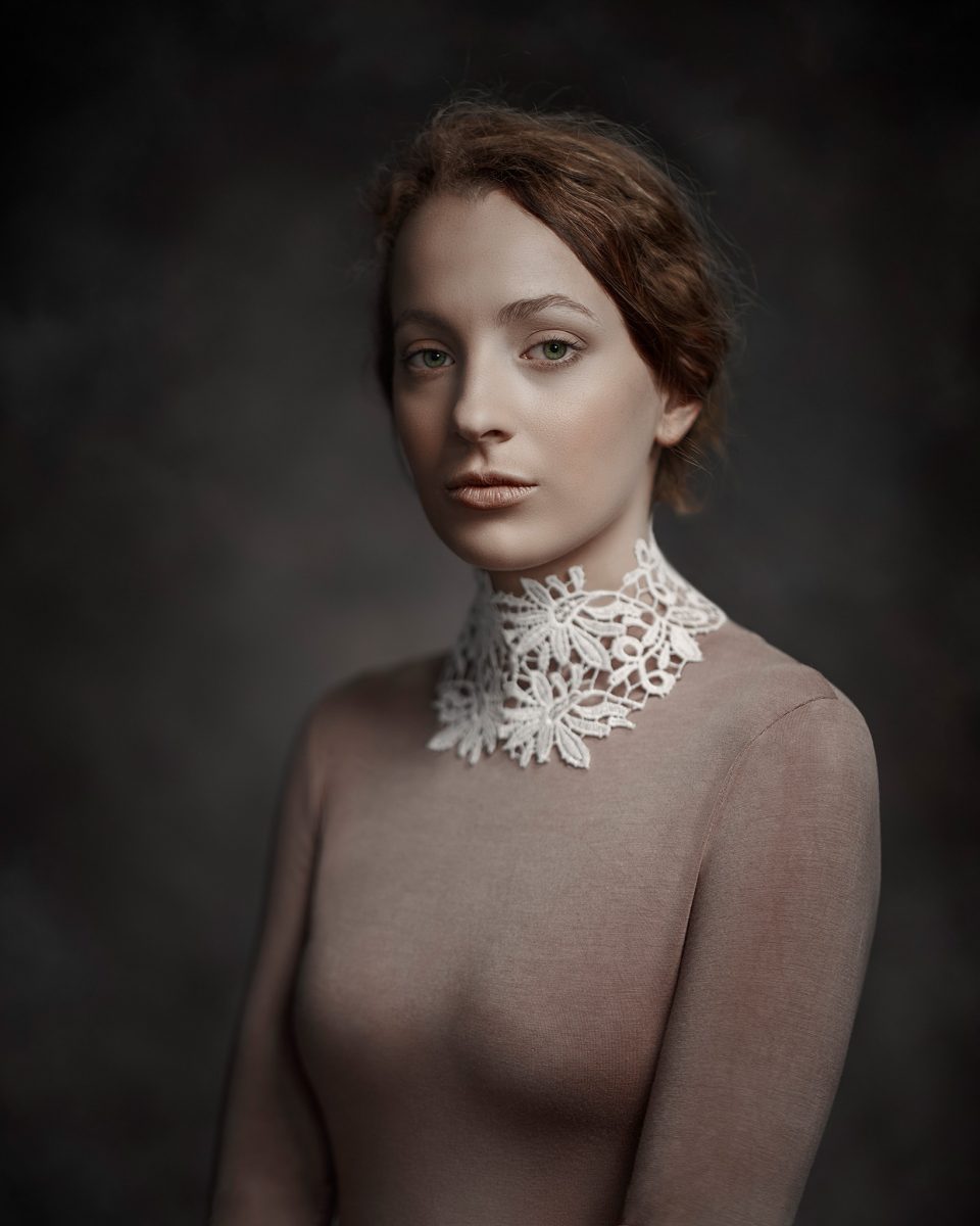 Portrait known as Seren, by Melbourne wedding photographer Rocco Ancora. Dressed an white lace collared top, lit with a broad lighting technique