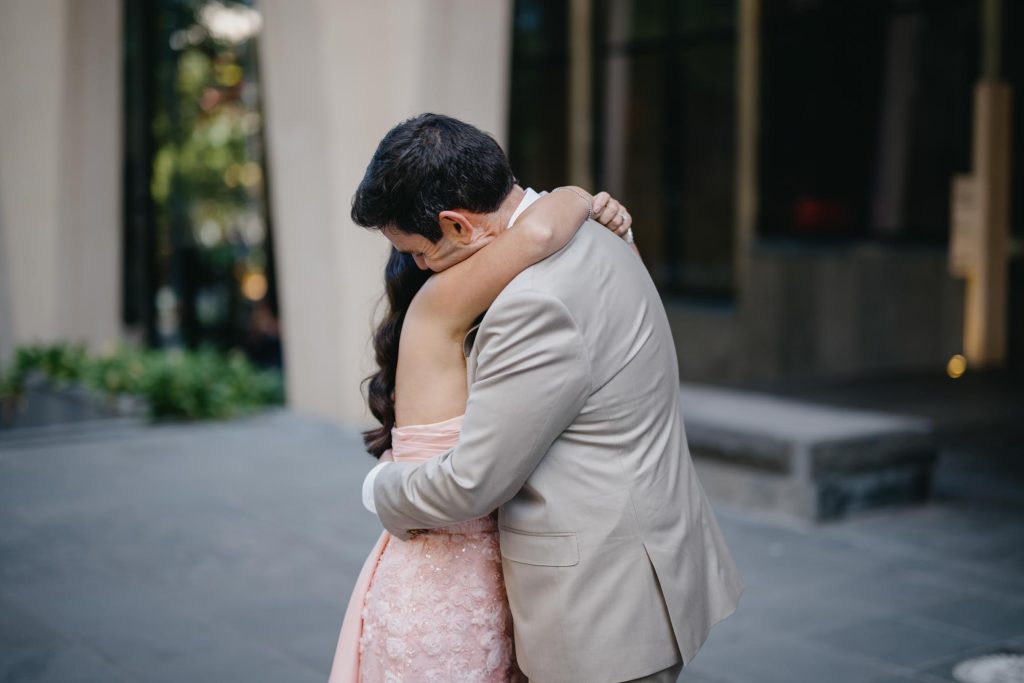ride and groom embracing during Melbourne city wedding portraits