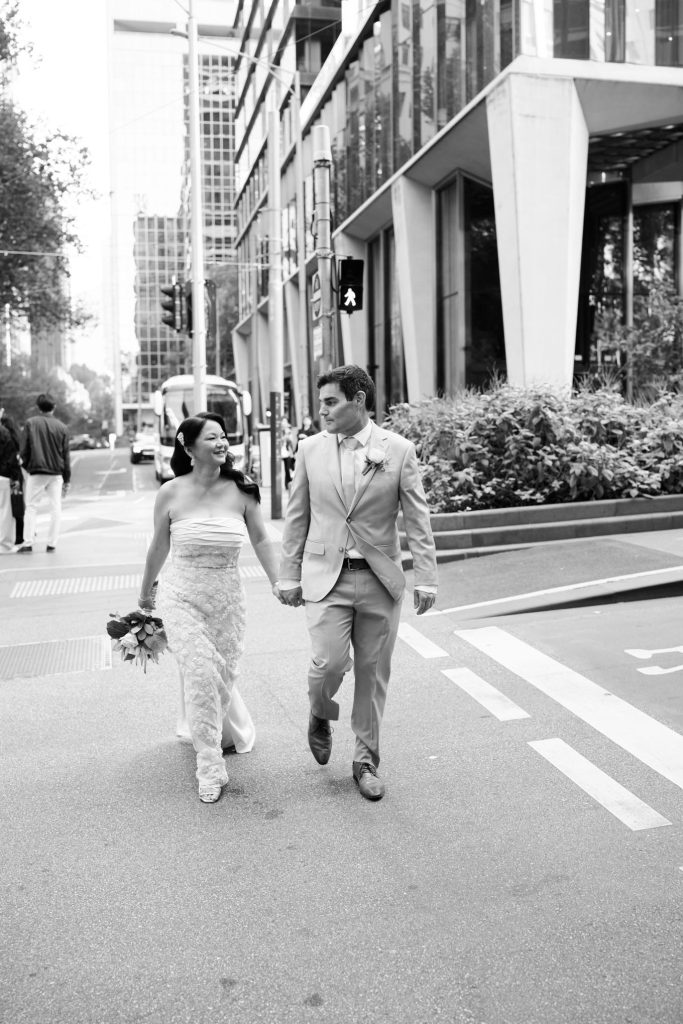 Bride and groom walking through Melbourne CBD before Federation Square wedding