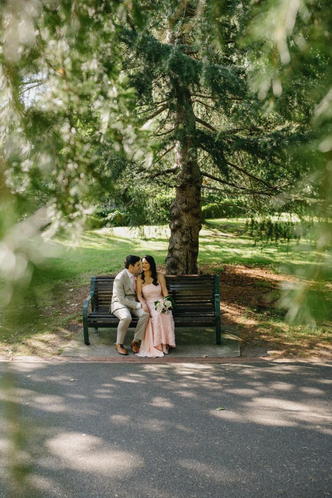 Couple seated together in Treasury Gardens Melbourne wedding portraits
