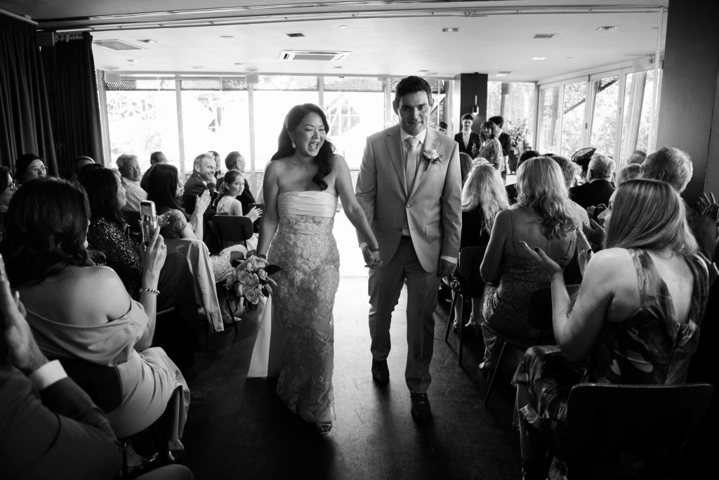 Bride and groom walking back down the aisle after Taxi Kitchen wedding ceremony