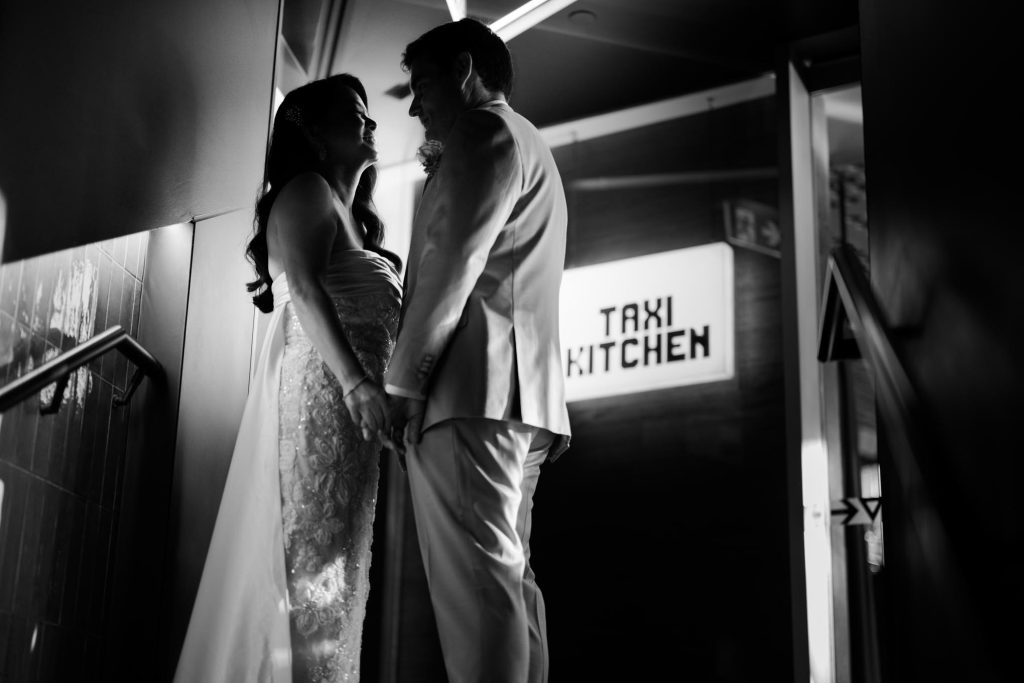 Black and white portrait outside Taxi Kitchen at Federation Square