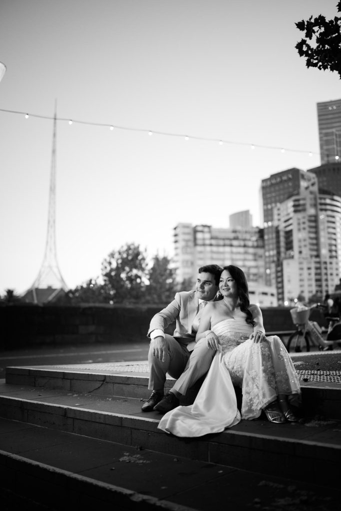 Bride and groom seated together at sunset in Melbourne CBD