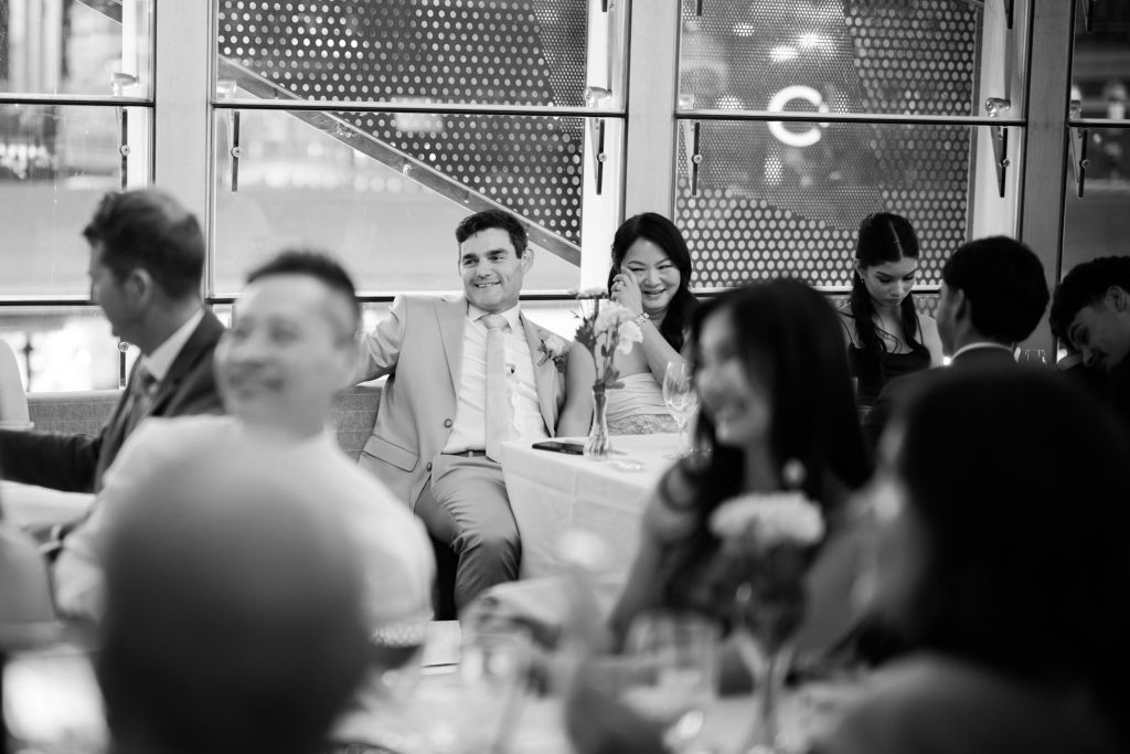 Bride and groom laughing during wedding reception speeches in Melbourne CBD