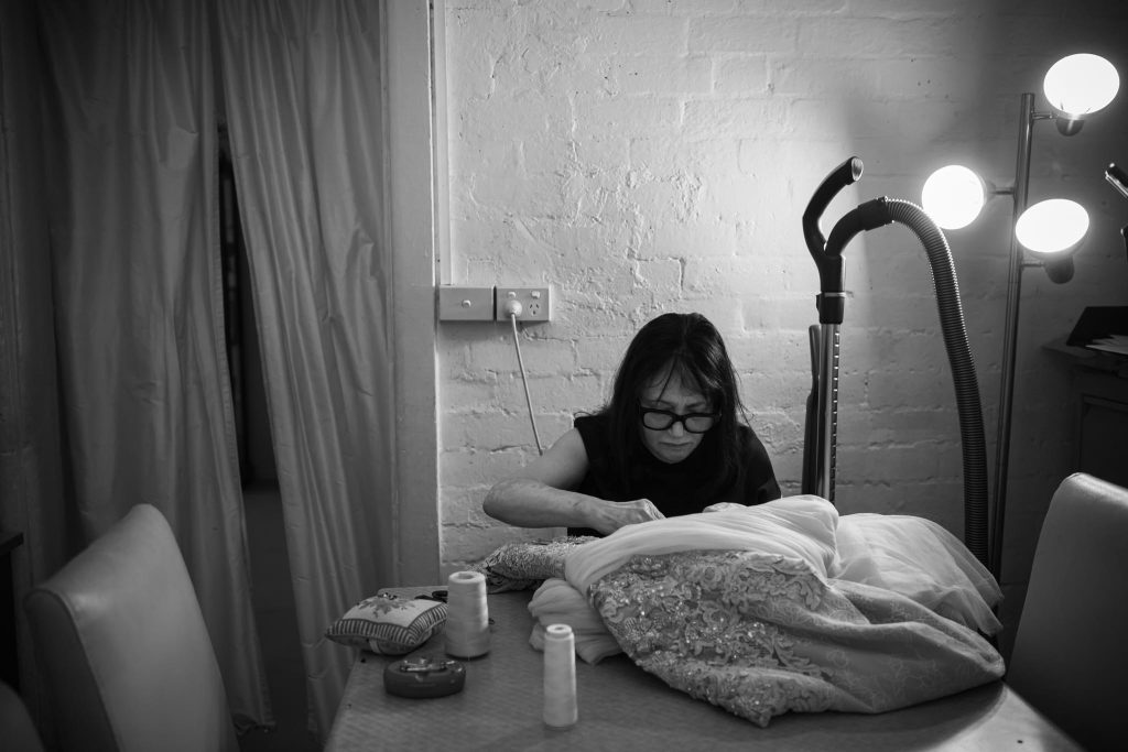 Rose sewing a couture wedding gown by hand inside the Annette of Melbourne workroom