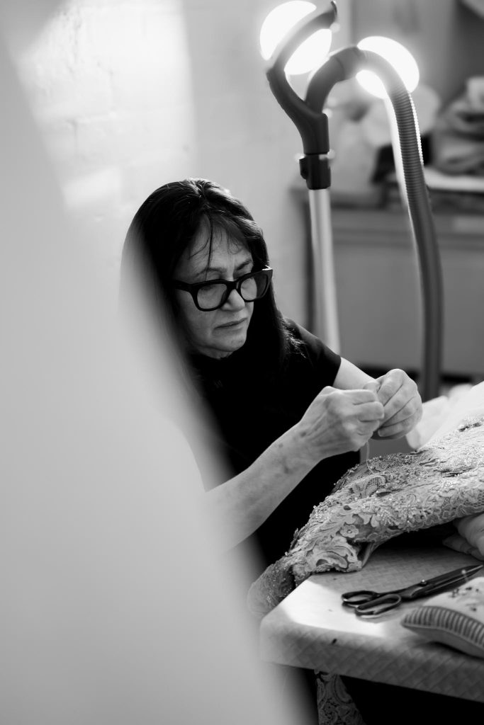Rose sewing a couture wedding gown by hand inside the Annette of Melbourne workroom